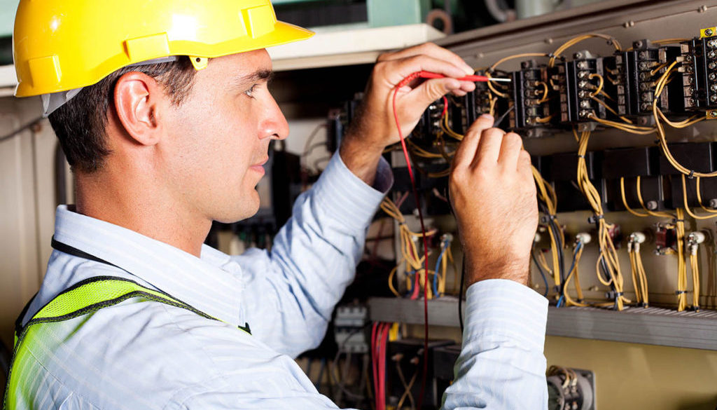electrician testing industrial machine